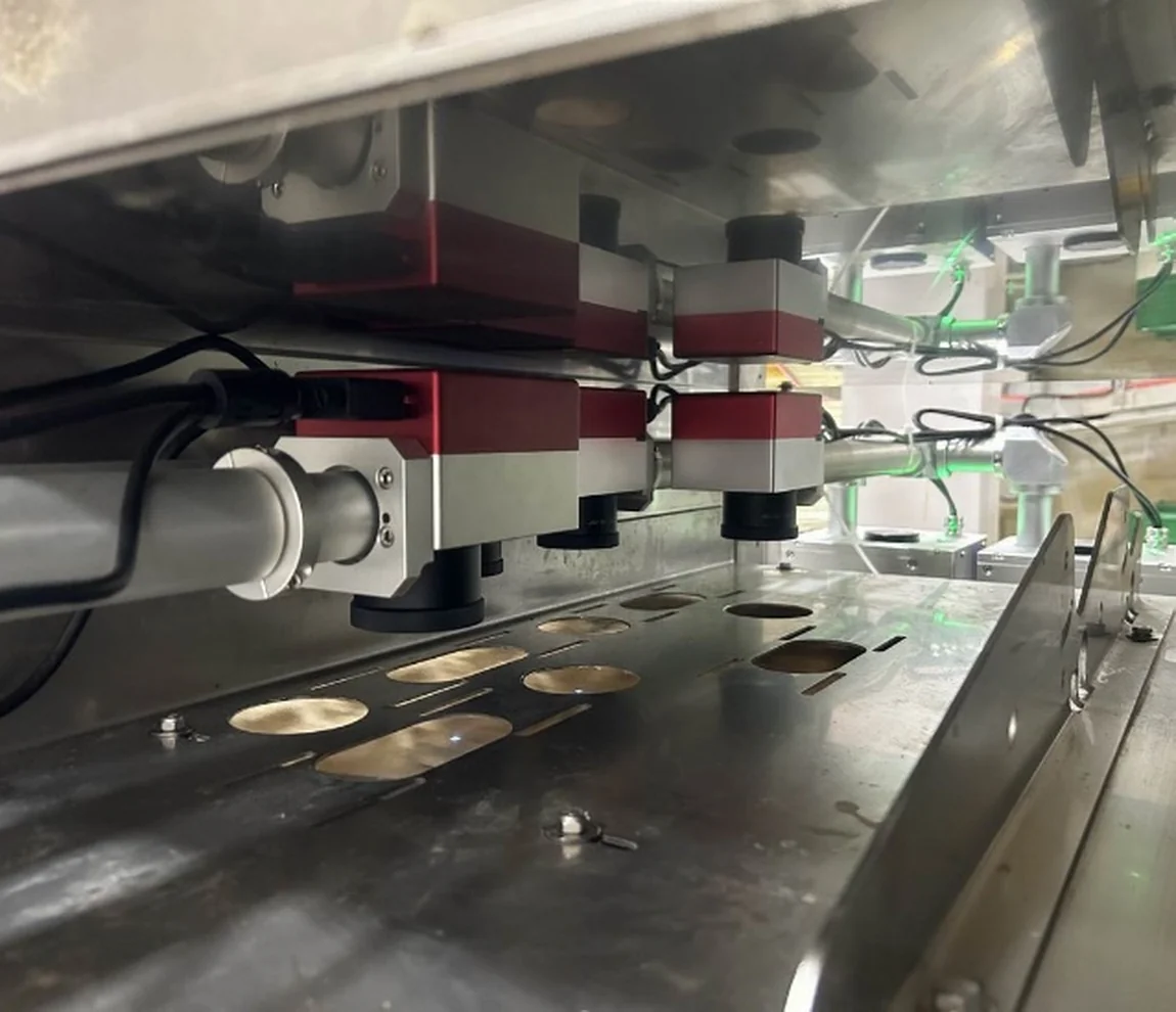 Multiple laser heads installed above an egg grading line